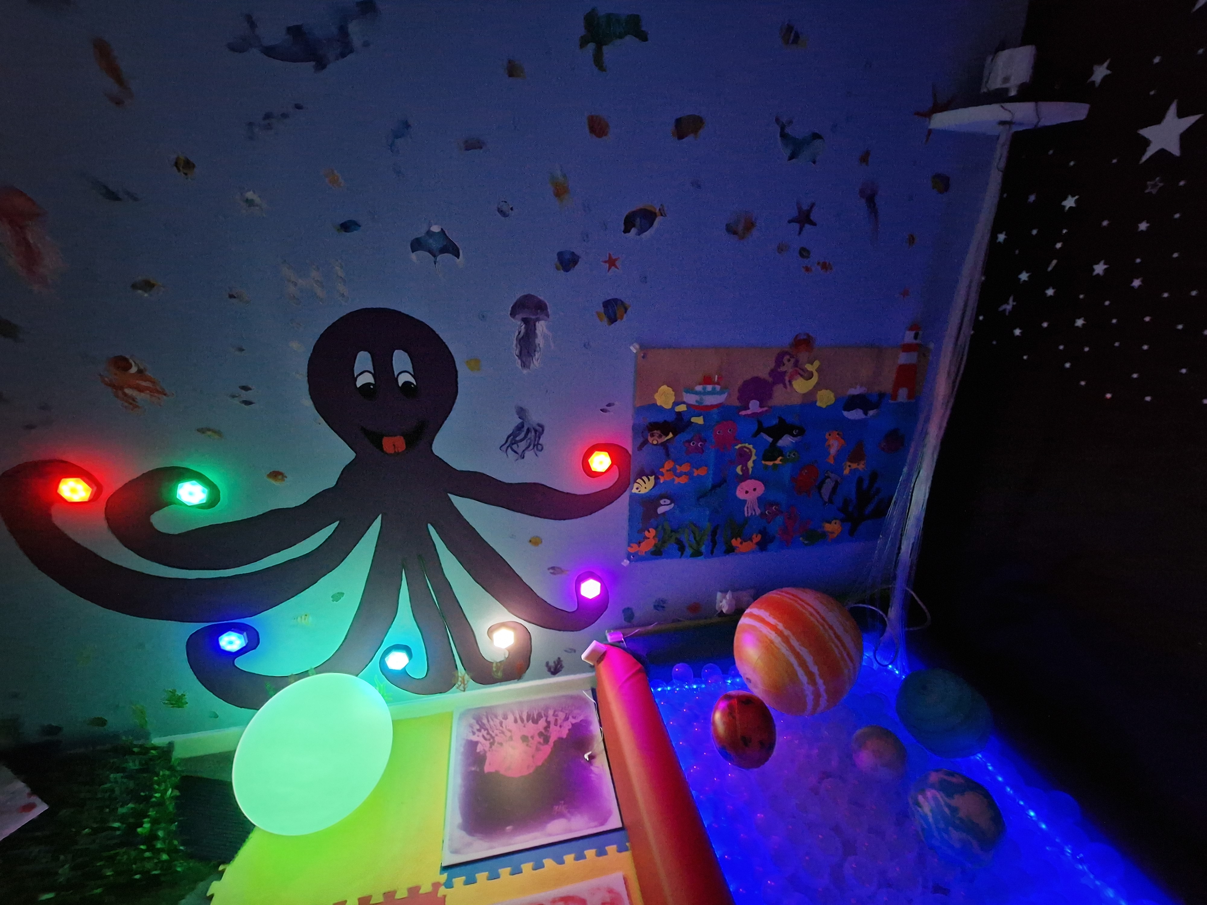 Soft-lit sensory wall with gentle visuals