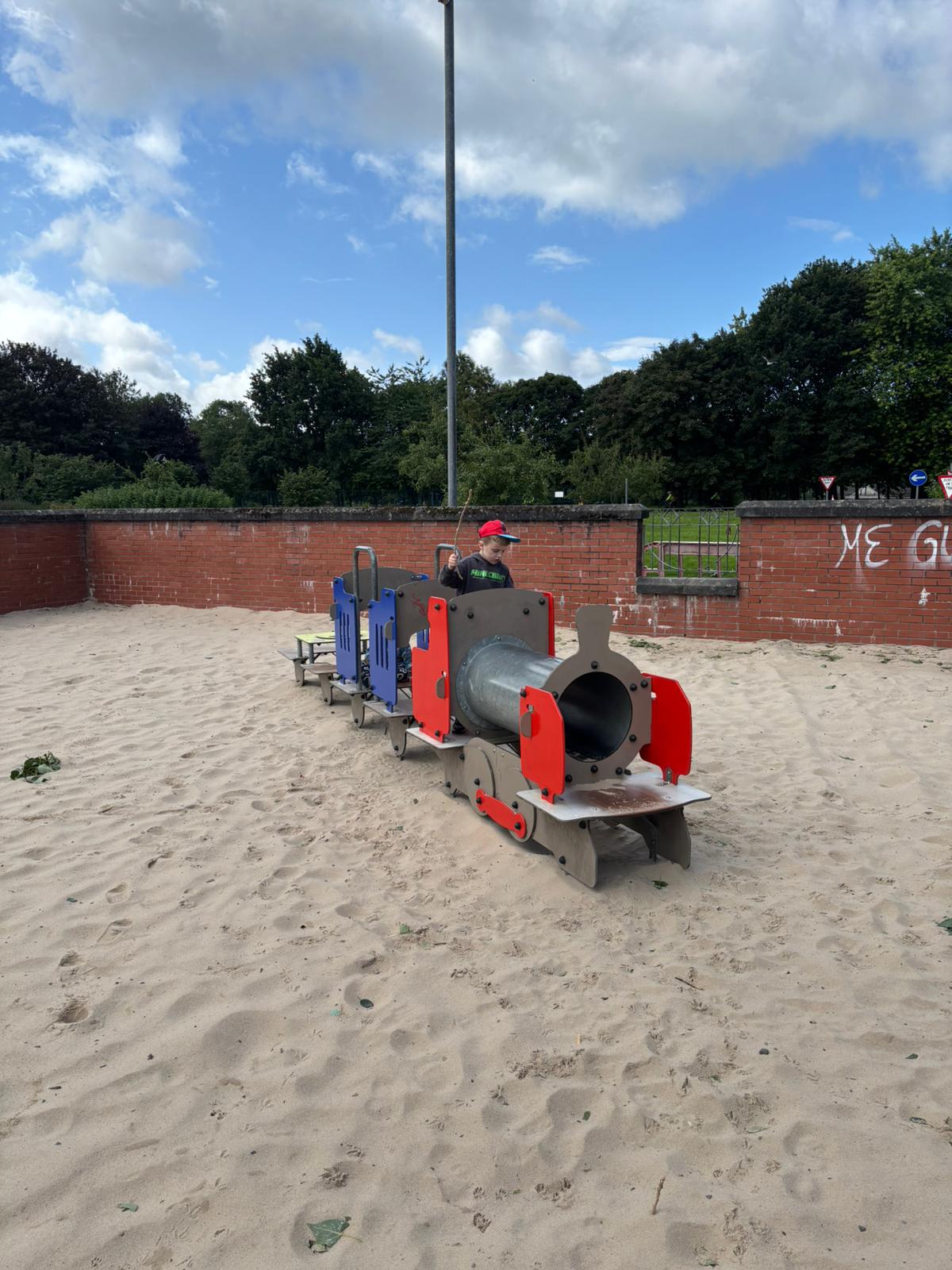 Child holding craft materials and smiling